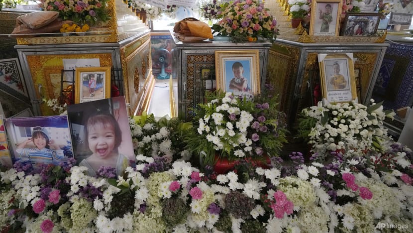 Grieving families pray at Thai temple for slain nursery victims