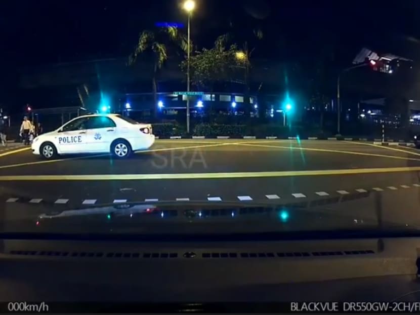 Caught on camera: A police car drove through a stop light at a T-junction in Bukit Batok on June 4.