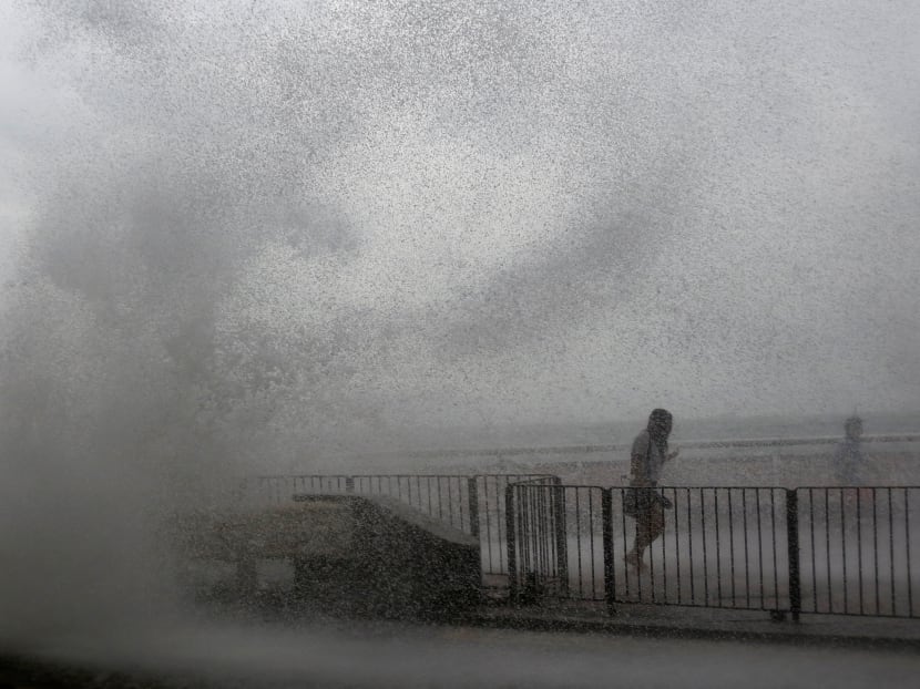 People run away from a big wave on a waterfront as Typhoon Haima approaches in Hong Kong, China, October 21, 2016. Photo: Reuters