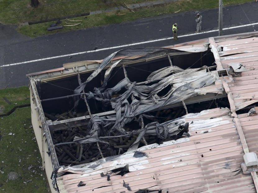 A warehouse which caught fire after an explosion is seen at the US Army Sagami General Depot in Sagamihara, southwest of Tokyo, Japan, in this aerial photo taken by Kyodo Aug 24, 2015. Photo: REUTERS/Kyodo