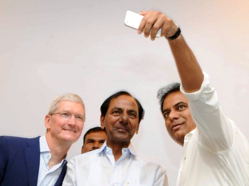 Tim Cook, left, Apple's chief executive, with Telangana state government officials in India in May. Photo: AFP