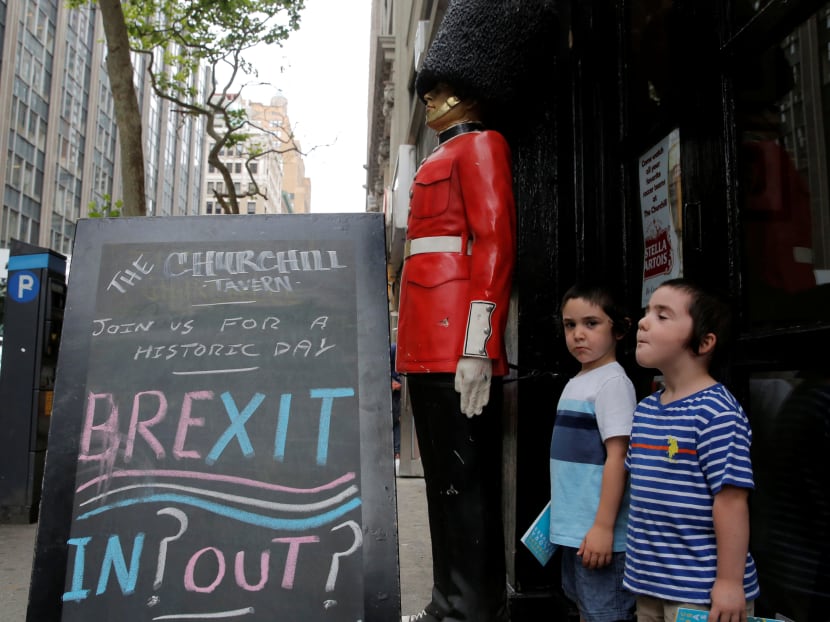 Children pose next to a chalkboard advertising a Brexit viewing event at "The Churchill Tavern", a British theme bar, on the day where Britain votes whether or not to remain in the European Union in the Manhattan borough of New York, U.S., June 23, 2016. Photo: Reuters