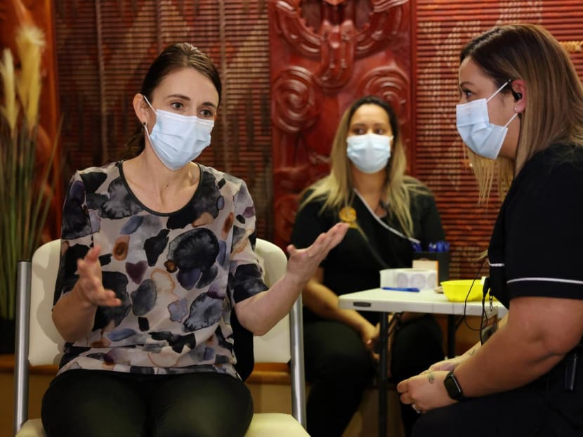 New Zealand's Prime Minister Jacinda Ardern speaks to a nurse as she receives her first dose of the Covid-19 coronavirus vaccine at the Manurewa vaccination centre in Auckland on June 18, 2021.
