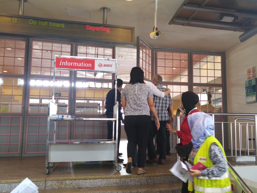 A man believed to be a relative of one of the deceased being ushered into Pasir Ris Station yesterday. 
Photo: Clifford Lee