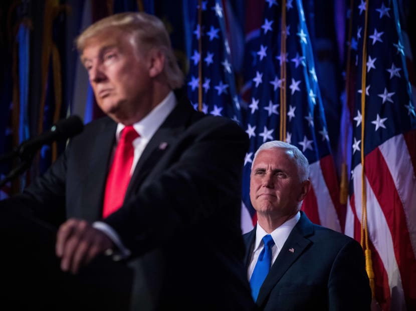 Mr Donald Trump speaks as his running-mate, Mike Pence, looks on at his election night party. The New York Times file photo.