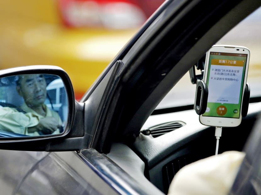 A Beijing driver using the Didi Chuxing car-hailing app. New rules will afford more legal status to the industry. PHOTO: REUTERS