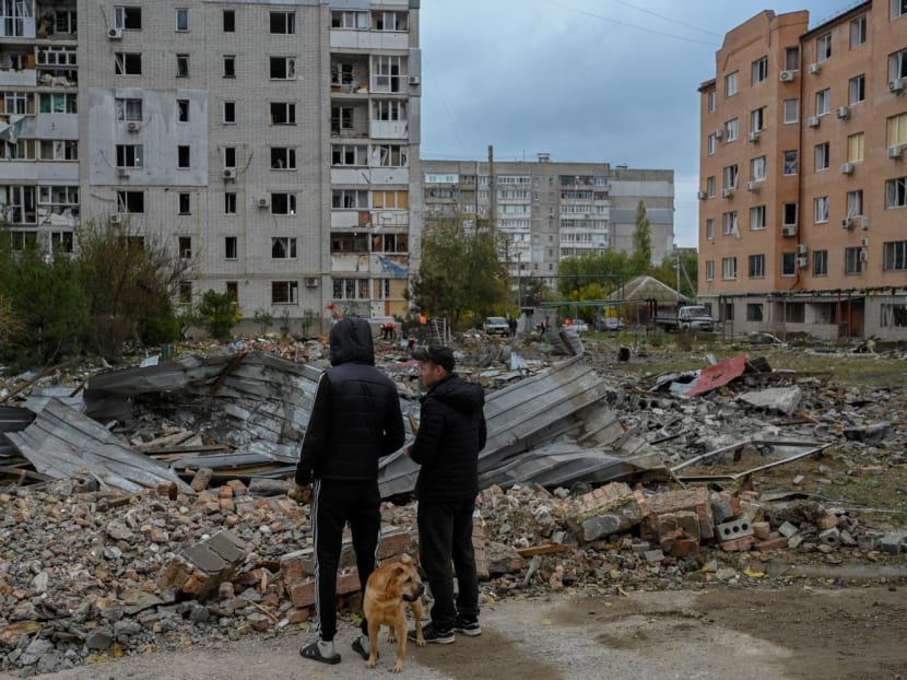 People look at the damages after a rocket attack in Mykolaiv on Oct 23, 2022, amid Russian invasion in Ukraine.