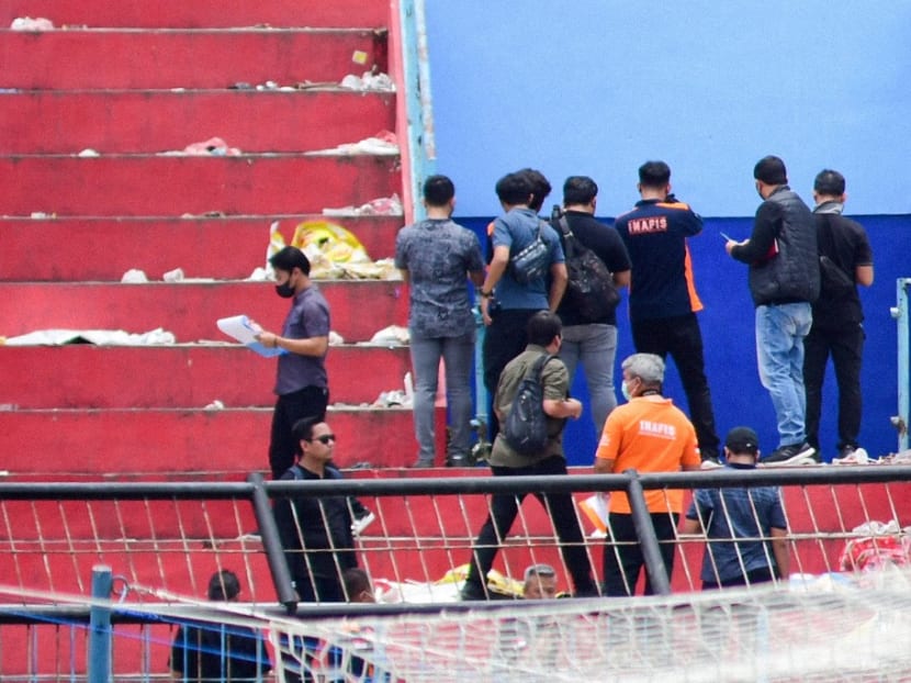 Indonesian police investigating at Kanjuruhan Stadium in Malang on Oct 13, 2022, following a stampede that killed at least 131 people in one of the deadliest disasters in football history.