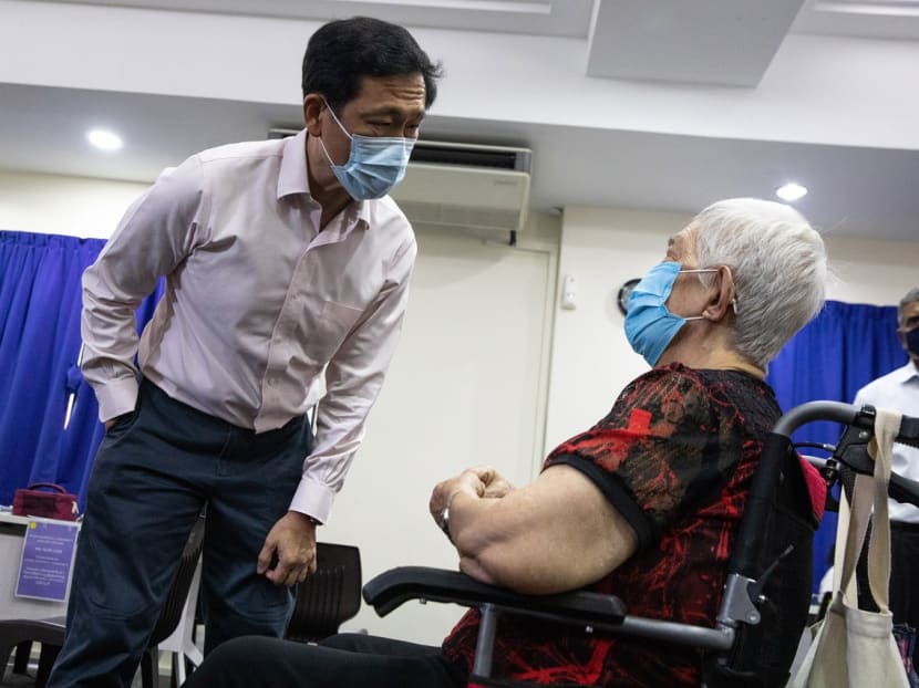 Health Minister Ong Ye Kung talking to woman who received the Covid-19 bivalent vaccine administered by the mobile vaccination team at Hong Kah Community Club on Dec 12, 2022. 