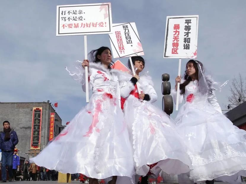 Li Maizi (left), pictured with fellow activists Xiao Yue and Wei Tingting campaigning in Beijing on Valentine's Day 2012 against domestic violence. Li Maizi (left), pictured with fellow activists Xiao Yue and Wei Tingting campaigning in Beijing on Valentine's Day 2012 against domestic violence.