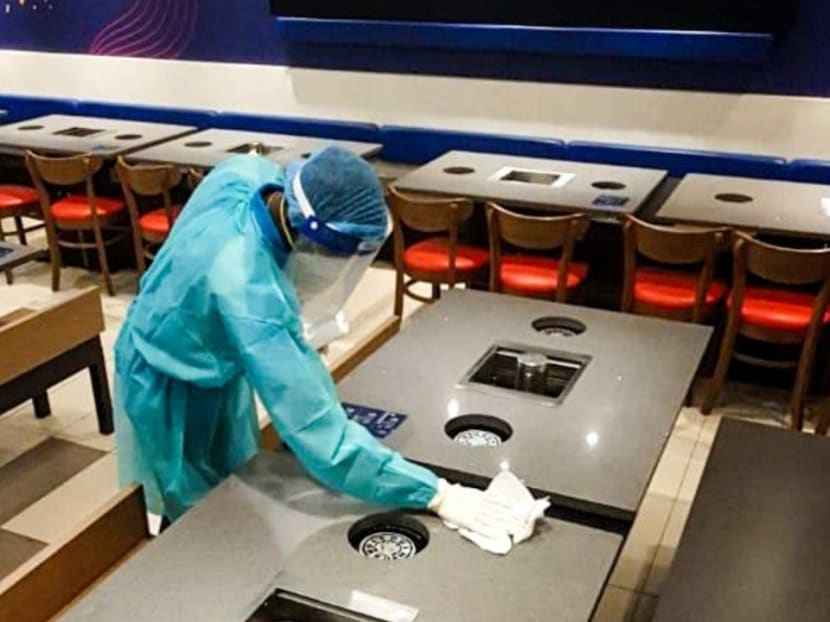 File photo dated Sept 20, 2020 of a worker carrying out disinfection at a Seoul Garden restaurant in an unnamed location.
