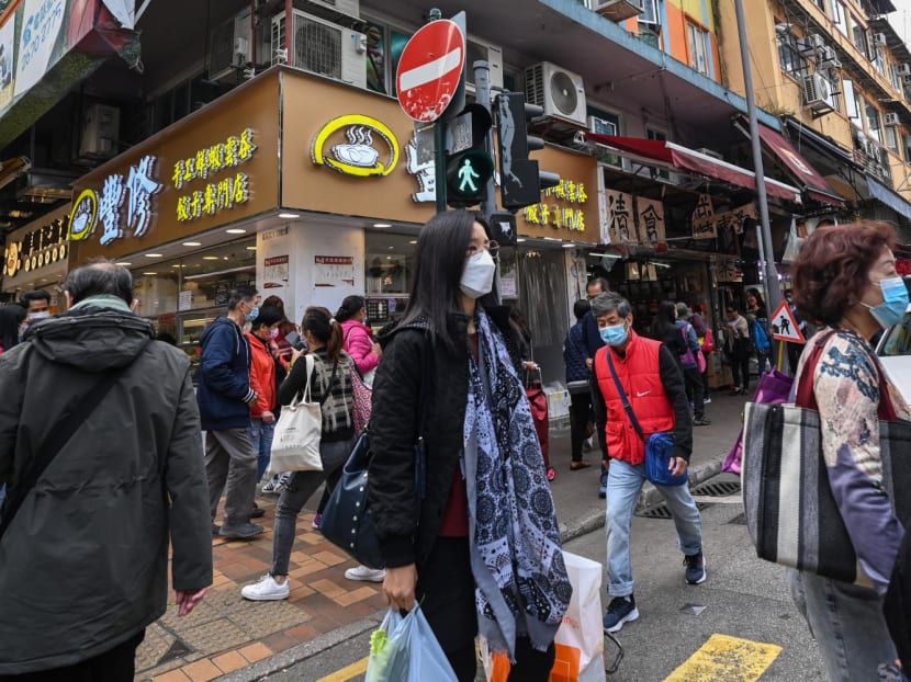 People walk along a street in the town of Sheung Shui near the border of mainland China in Hong Kong on Jan 4, 2023 ahead of the opening of the border on Jan 8. People walk along a street in the town of Sheung Shui near the border of mainland China in Hong Kong on Jan 4, 2023 ahead of the opening of the border on Jan 8.