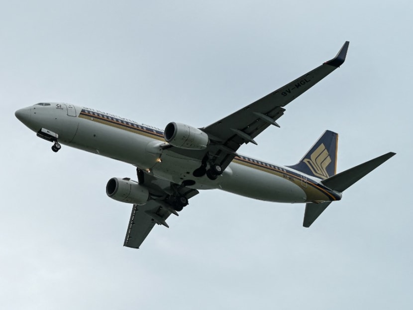 A Singapore Airlines passenger plane approaches for landing at Singapore Changi Airport in Singapore on June 20, 2022.