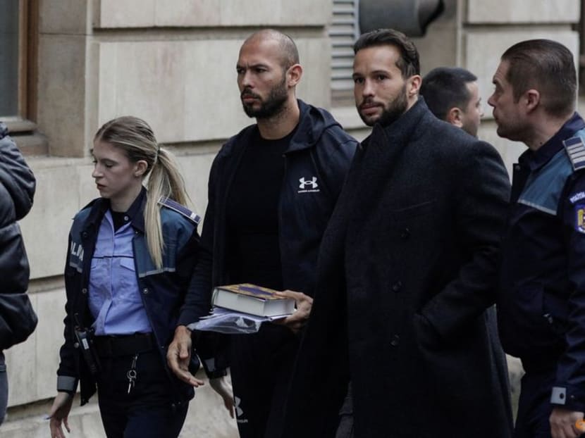 FILE PHOTO: Andrew Tate and his brother Tristan are escorted by police officers outside the headquarters of the Bucharest Court of Appeal, in Bucharest, Romania, January 10, 2023. Inquam Photos/Octav Ganea via REUTERS FILE PHOTO: Andrew Tate and his brother Tristan are escorted by police officers outside the headquarters of the Bucharest Court of Appeal, in Bucharest, Romania, January 10, 2023. Inquam Photos/Octav Ganea via REUTERS