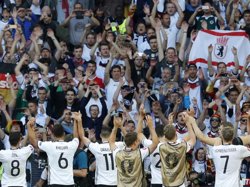 Germany players celebrate in front of fans after the game. Photo: Reuters