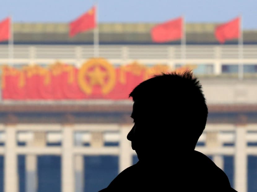 A man is seen silhouetted at the Great Hall of the People in Beijing, China. China unveils a “revolutionary” government restructuring plan that consolidates Communist Party authority, giving President Xi Jinping more direct control over the levers of money and power. Photo: Reuters