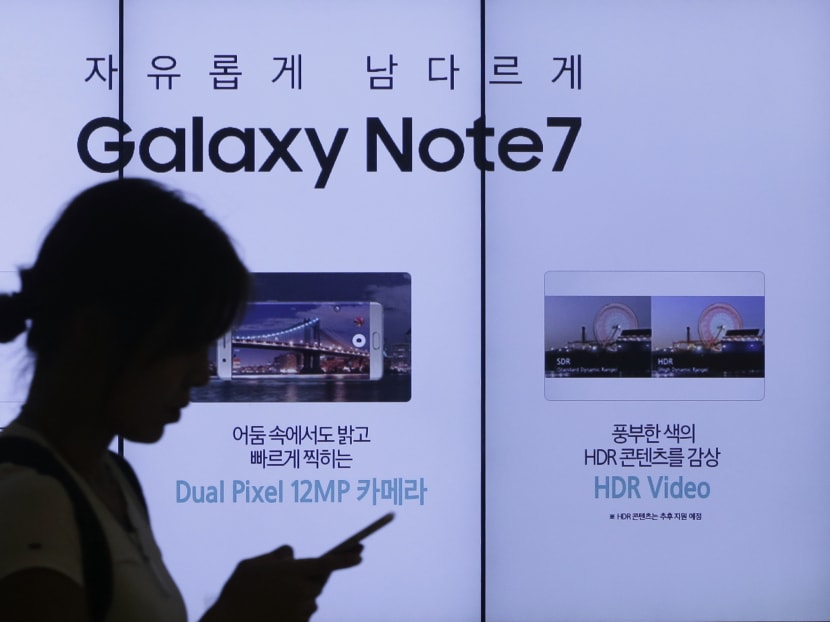 In this Sept 2, 2016, file photo, a woman walks by an advertisement of the Samsung Electronics Galaxy Note7 smartphone at the company's showroom in Seoul, South Korea. Photo: AP