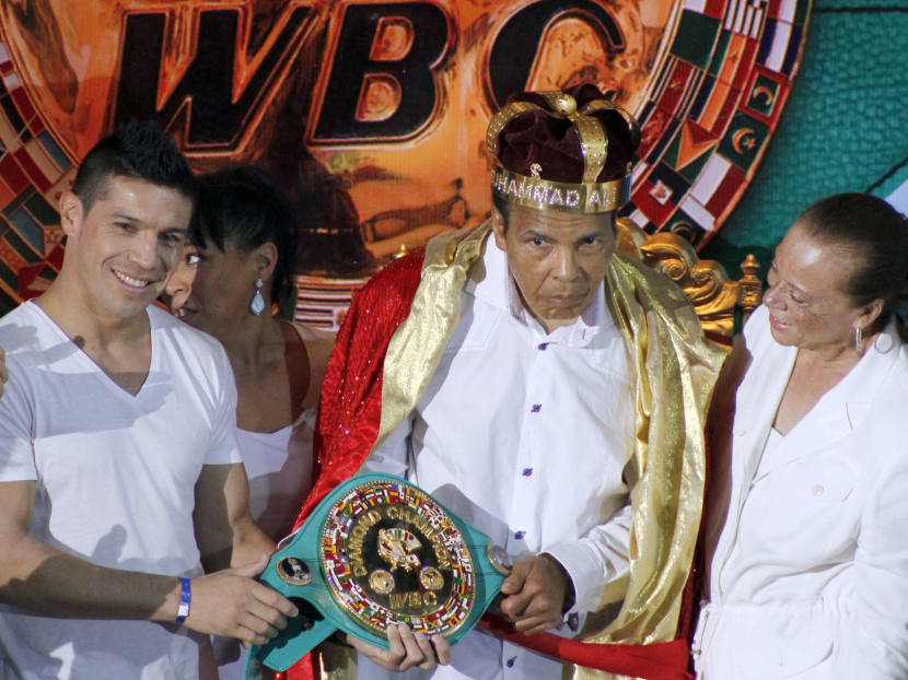 The former heavyweight boxing champion Muhammad Ali (centre) is crowned King of Boxing while accompanied by his wife, Lonnie (right) and Argentine boxer Sergio Martinez during the 50th convention of the World Boxing Council in Cancun, Mexico, Dec 3, 2014. Photo: AP