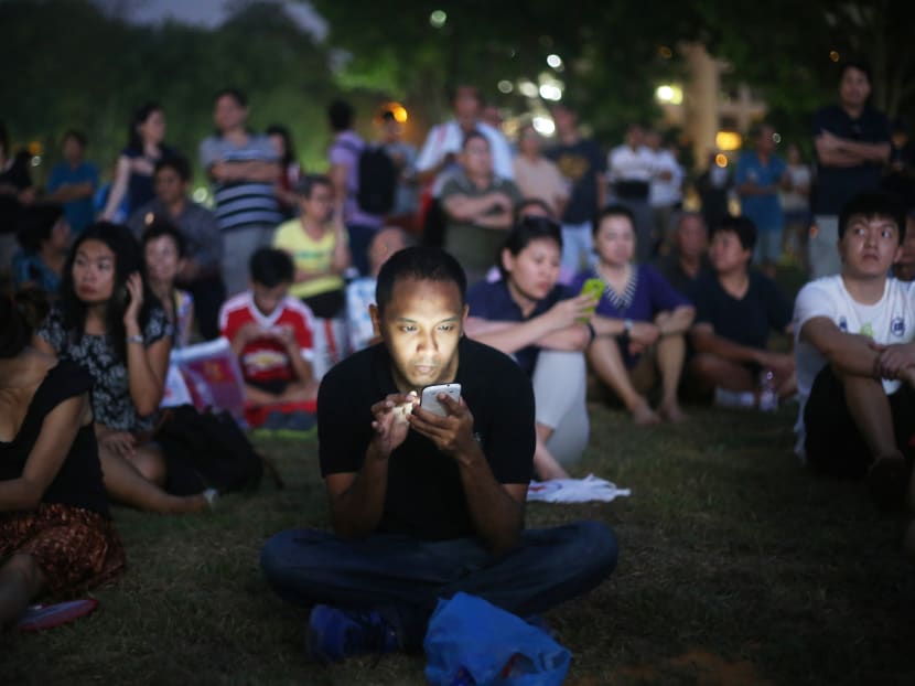A man looking at his handphone at a Singapore People's Party rally on Sept 8, 2015. In light of the Covid-19 situation, analysts are expecting political parties to be delivering their messages online instead of holding outdoor rallies during campaigning for the coming General Election.