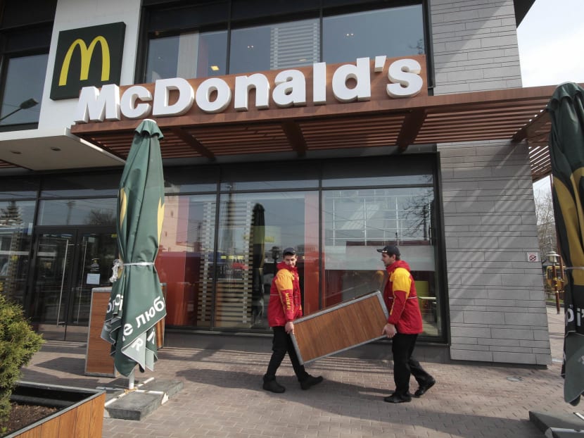 Employees remove a trash can outside a McDonald's restaurant. Photo: Reuters file photo