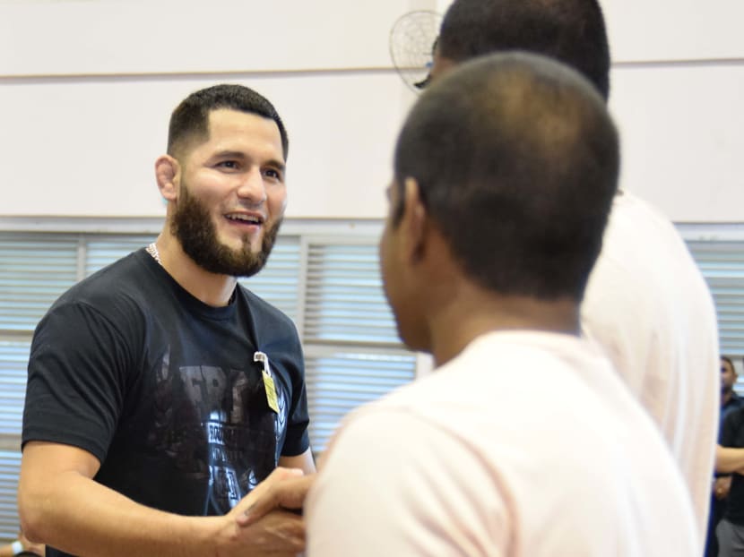 Jorge Masvidal shaking hands with Singapore Boys Home residents after his session with them. Photo: Singapore Boys' Home