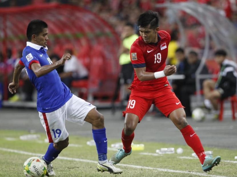 Singapore's Khairul Amri (in red) contesting with Malaysia's Azammuddin bin Mohd Akilat the AFF Suzuki Cup 2014 on 29 Nov 2014. TODAY File Photo