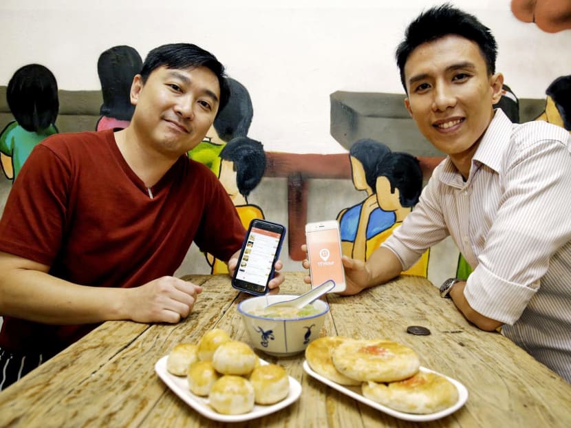 Founder of 11th Hour Tan Jun Yuan (right) with Mr Jordy Lam, one of three partners behind The Happy World cafe. Mr Tan said his app could feature larger chains, franchises, hawkers and supermarkets in future. Photo: Wee Teck Hian