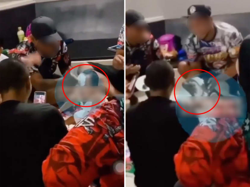 Screenshots from a video that showed adults smearing cake and cream on a toddler's face.
