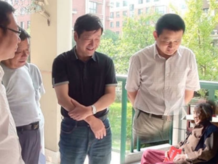 Officials in China's Anhui province have apologised for this edited photograph, showing the vice-mayor minus his legs looming over a miniaturised senior citizen. Photo: The Guardian/Ningguo Civil Affairs Department