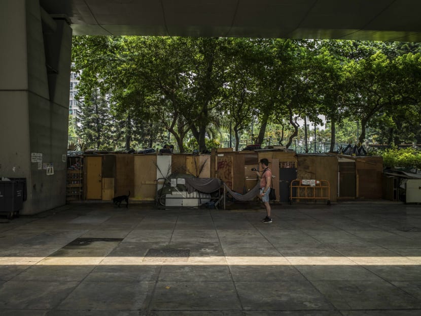 A tourist taking photos of makeshift homeless shelters in Hong Kong's  Sham Shui Po. Photo: The New York Times