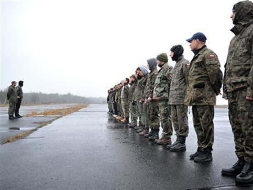 In this photo taken in Szczecin, Poland, on Wednesday, March 11, 2015, members of paramilitary National Guard muster near Szczecin, Poland, as they ready themselves to counter threats and contain crisis situations in their area. Photo: AP