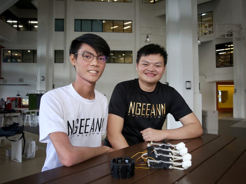 Ngee Ann Polytechnic students Ho Soon Yee (left) and Joshua Tan, from the Diploma in Engineering Science course, designed a glove to help stroke victims relearn how to grasp their hands.