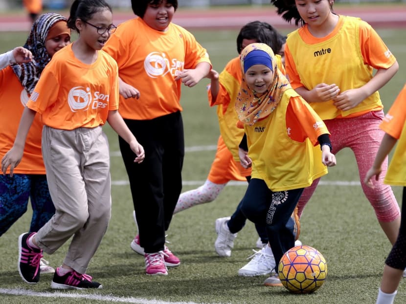 Some 130 girls and young women joined in the Play Like a Girl football camp yesterday at Serangoon Stadium. Photo: Jason Quah