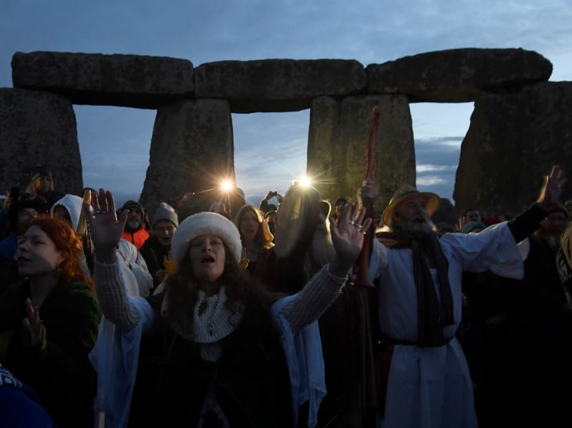 Photo of the day: Visitors and revellers react amongst the prehistoric stones of the Stonehenge monument at dawn on Winter Solstice, the shortest day of the year, near Amesbury in south west Britain, Dec 21, 2016. Photo: Reuters