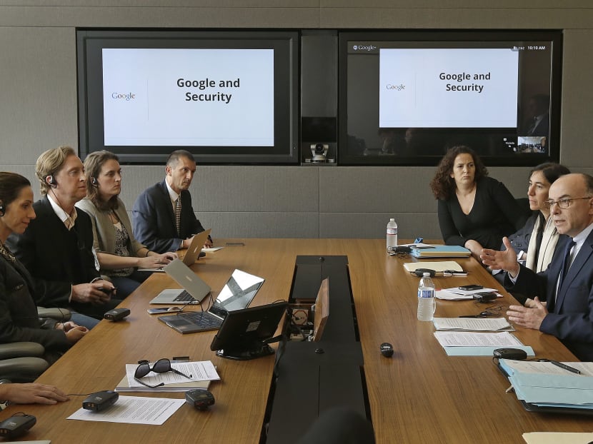French Interior Minister Bernard Cazeneuve, right, gestures during a meeting with Google executives yesterday (Feb 20) at Google headquarters in Mountain View, California. Photo: AP