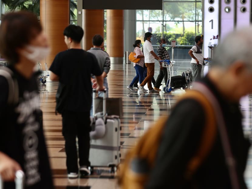 Travellers are seen at the departure hall of Changi Airport Terminal 3 on 14 Feb, 2021.