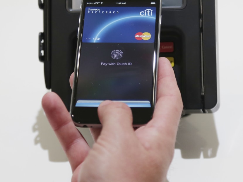 Apple Pay is demonstrated at Apple headquarters on Thursday, Oct. 16, 2014 in Cupertino, Calif. In announcing a Monday launch date, Apple CEO Tim Cook said deals have been made with hundreds of additional banks since the service was announced last month. Cook also said additional merchants plan to accept Apple Pay by the end of the year. Source: AP