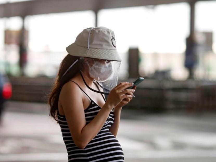 A pregnant woman wears a protective face mask due to the coronavirus disease (COVID-19) outbreak, as she came out from Suvarnabhumi Airport at Bangkok, Thailand March 20, 2020.