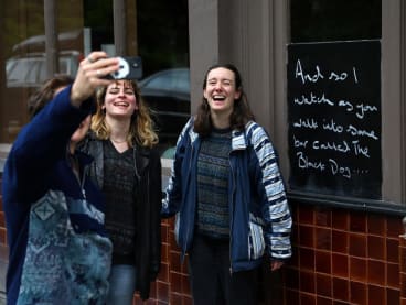 Fans of Taylor Swift take images next to lyrics from the song The Black Dog by Taylor Swift, written outside The Black Dog pub, believed by its owners to have been referenced in the track, in London, Britain, on April 22, 2024.