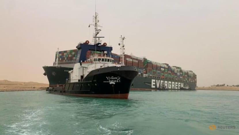 Tugs work to free giant container ship stranded in Suez Canal Tugs work to free giant container ship stranded in Suez Canal