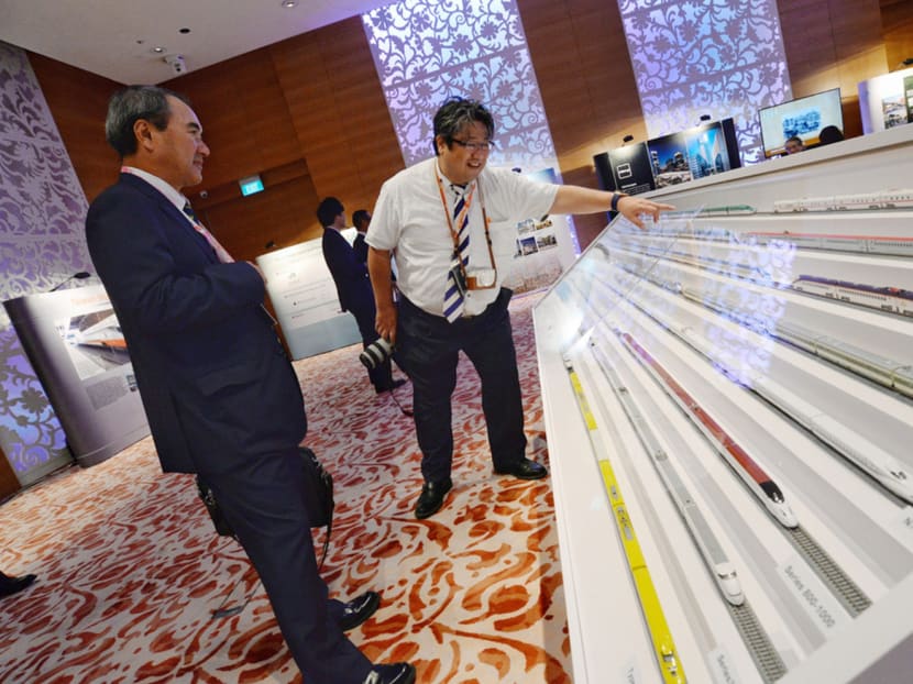 Rail industry players viewing scale models of Japanese high-speed trains at the Third High-Speed Rail Symposium here yesterday. Japan plans to take part in the tender for the HSR project. Photo: Robin Choo