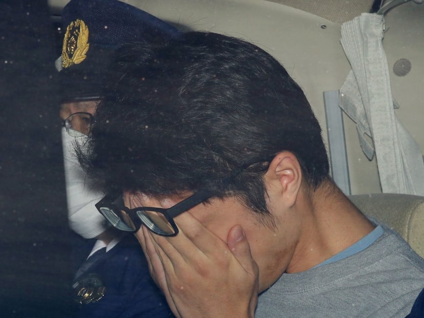 Takahiro Shiraishi covers his face inside a police car in Tokyo, in this photo taken by Kyodo in November 2017 and released by Kyodo on Tuesday, Dec 15, 2020.
