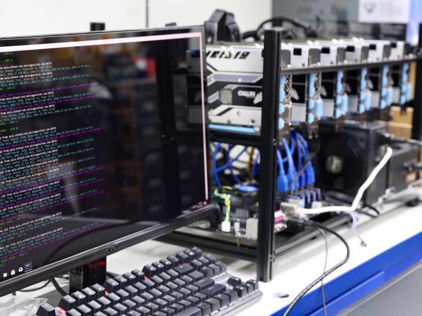 (Right) A bitcoin mining rig and (left) a monitor with the Software programme to mine the cryptocurrency is running, taken on January 26, 2018. Photo: Koh Mui Fong/TODAY