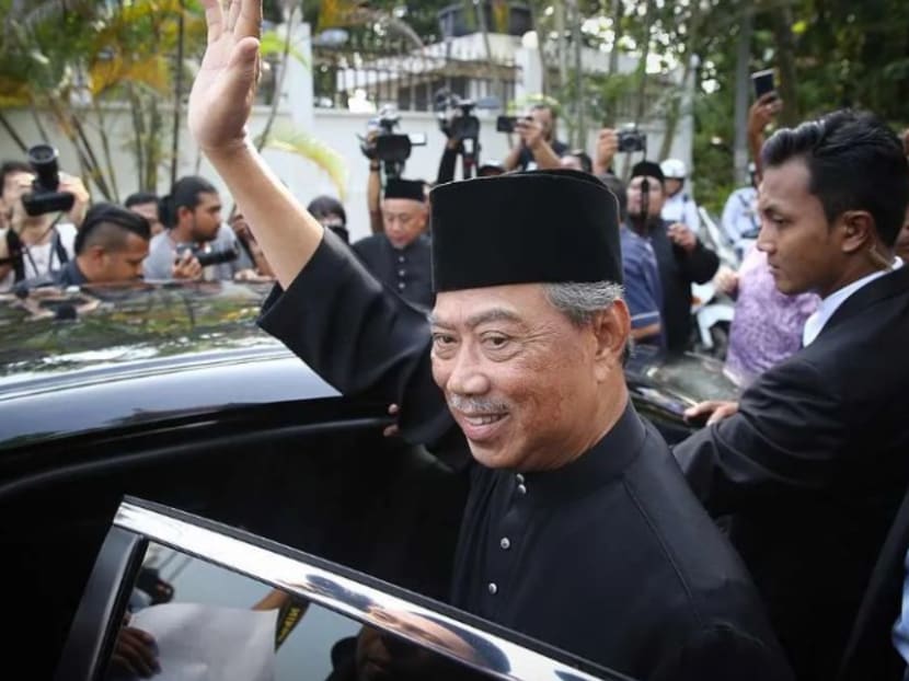 Malaysian PM Muhyiddin Yassin waves before heading for the Istana Negara in Kuala Lumpur to be sworn in on March 1, 2020.