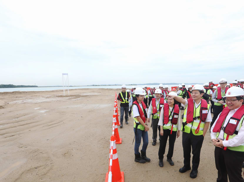 From right to left: Mr Yap Tiem Yew, Group Director of Building & Infrastructure, HDB; Mr Lawrence Wong, Minister for National Development and Second Minister for Finance; and Dr Cheong Koon Hean, CEO, HDB, seen during the visit to the polder site at Pulau Tekong on Nov 16, 2016. Photo: Koh Mui Fong/TODAY