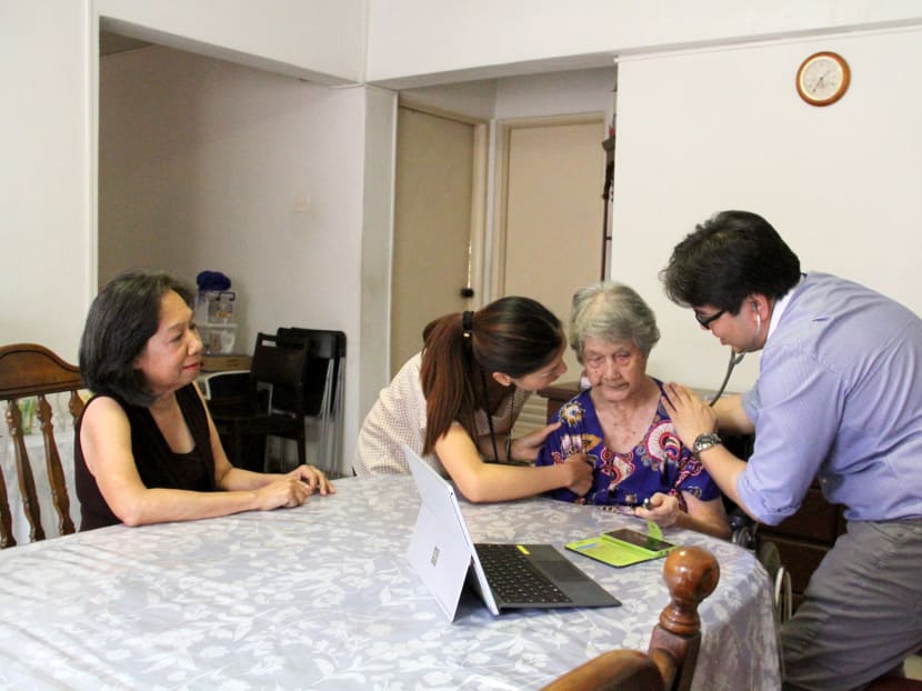 Programme Dignity allows end-stage dementia patients like Madam Monica Fernandez (second from right) to be cared for in the comfort of her own home. Photo: Esther Leong/TODAY