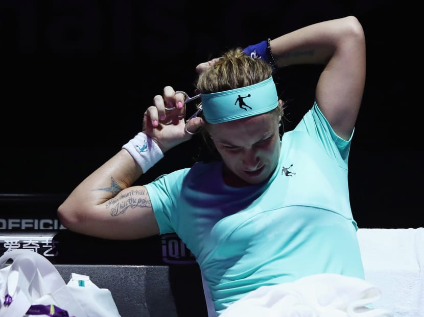 Kuznetsova cut off some of her hair in the second set before returning to finish the match. Photo: Getty Images