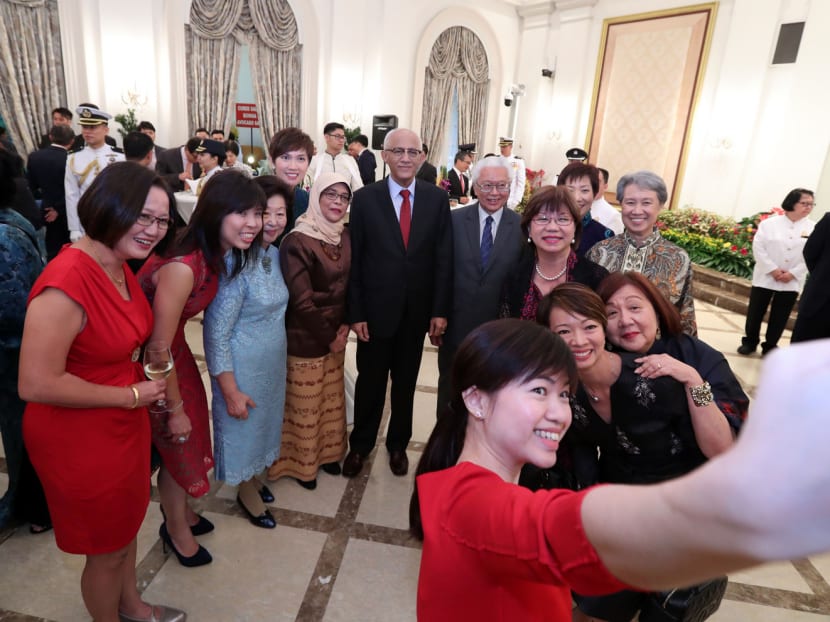 President Halimah Yacob and her husband Mohamed Alhabshee posing for a ‘wefie’ with guests, including former President Tony Tan and his wife Mary Tan, and Ms Ho Ching. Photo: Ministry of Communications and Information
