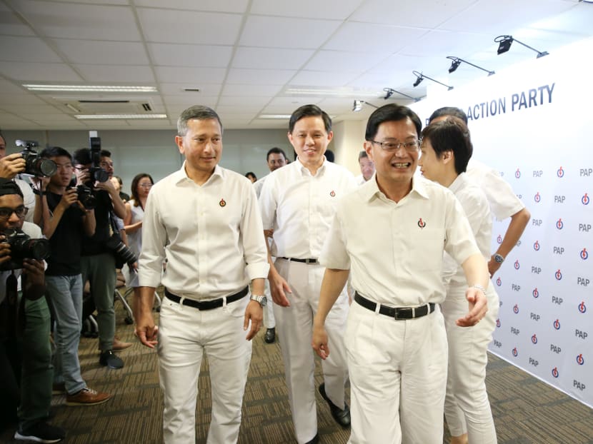 Finance Minister Heng Swee Keat and Trade and Industry Minister Chan Chun Sing leaving a press conference, shortly after the People’s Action Party unveiled its slate of office-bearers on its new Central Executive Committee.