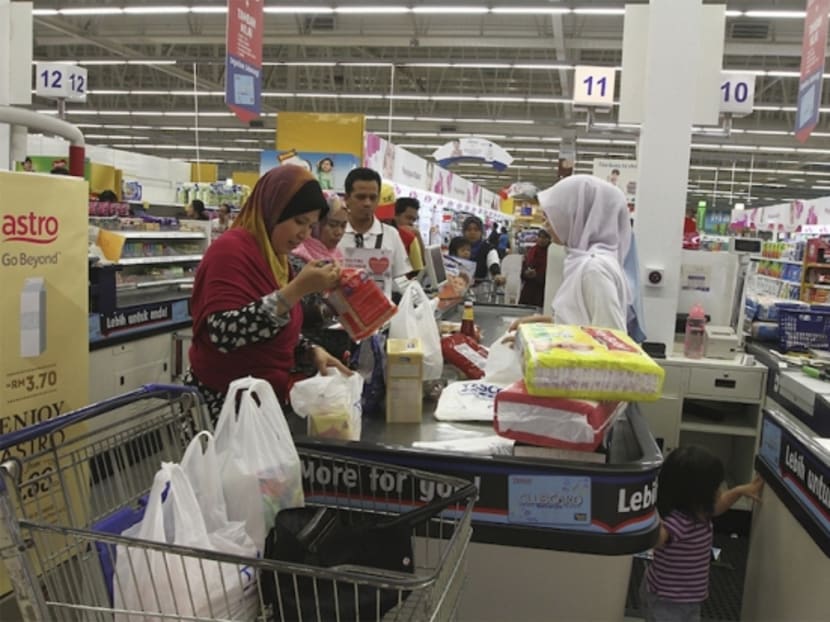 A shopper pays for groceries at the Tesco Extra supermarket in Shah Alam March 29, 2015 before the implementation of the GST on April 1. Photo: Malay Mail Online